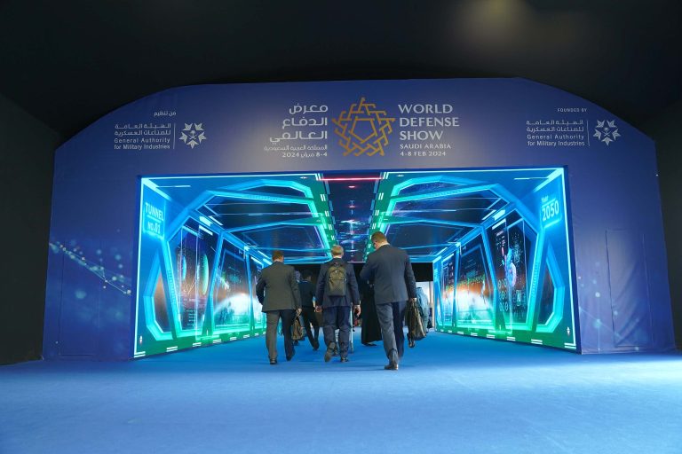 Cyber intelligence exhibition booth with neon blue-green lighting at World Defense Show Saudi Arabia 2024