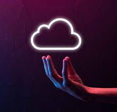 Hand holding a glowing neon cloud icon symbolizing secure cloud computing and digital transformation services